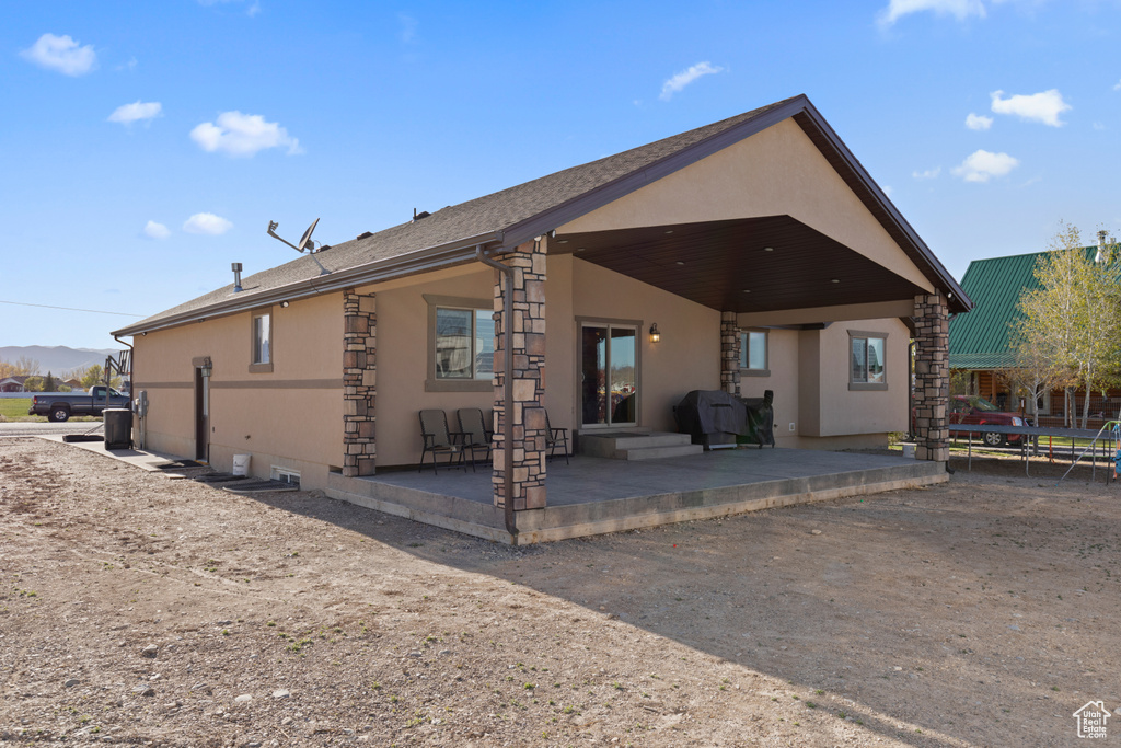 Rear view of property featuring a patio