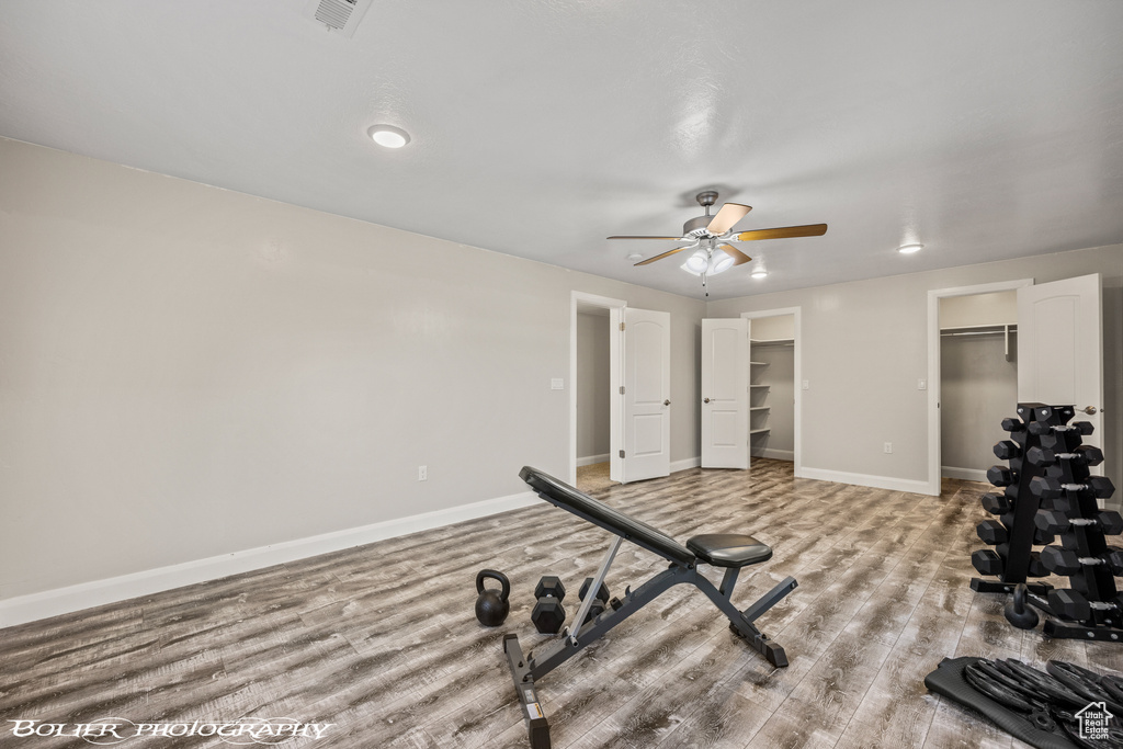 Workout area featuring hardwood / wood-style flooring and ceiling fan