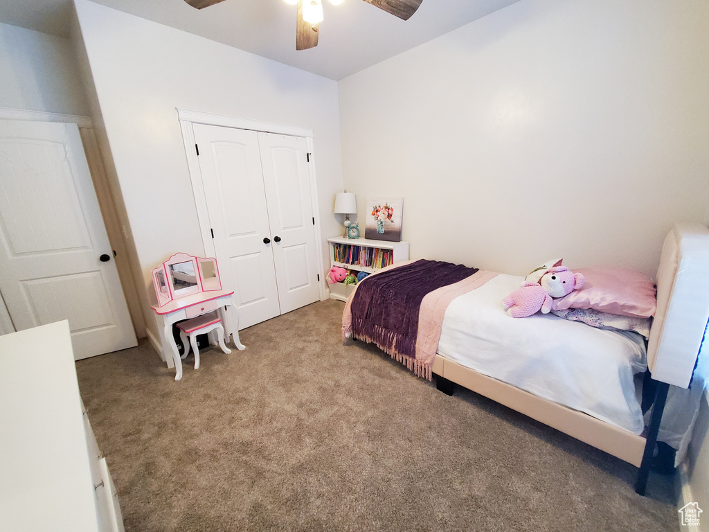 Bedroom with a closet, carpet floors, and ceiling fan
