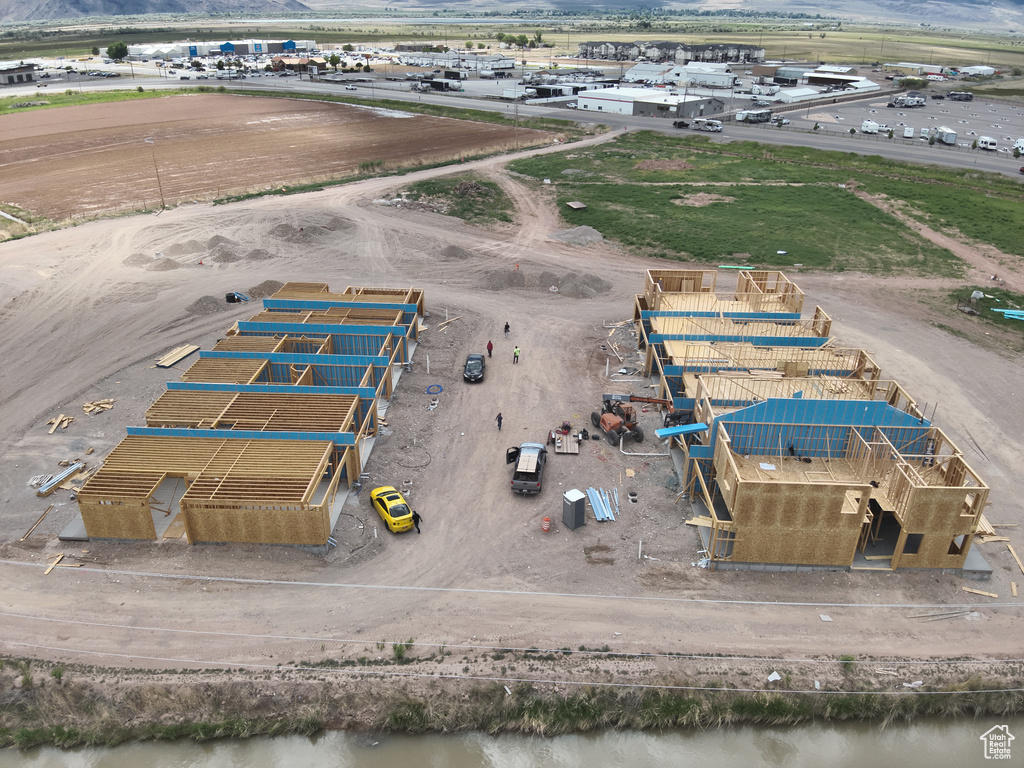 Birds eye view of property with a water view