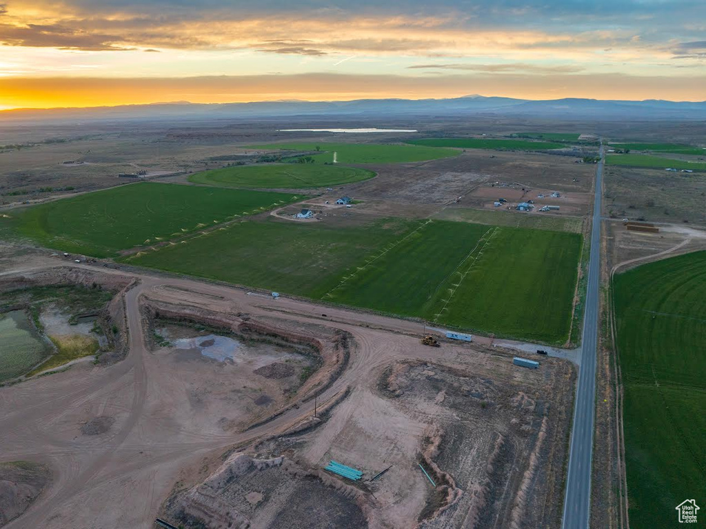 Aerial view at dusk featuring a rural view and a mountain view