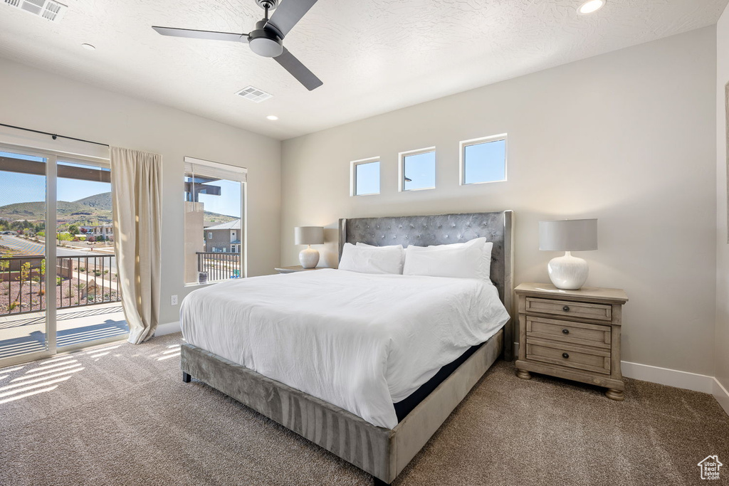 Bedroom featuring multiple windows, carpet floors, ceiling fan, and access to outside