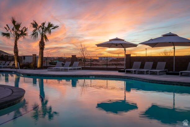 Pool at dusk with a patio area