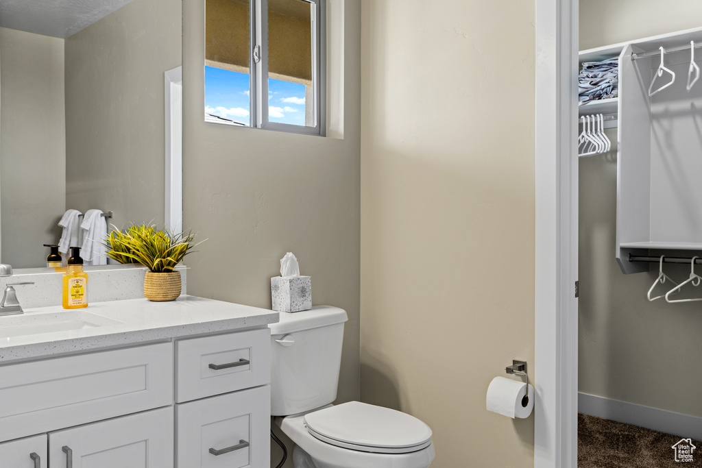 Bathroom featuring toilet and large vanity