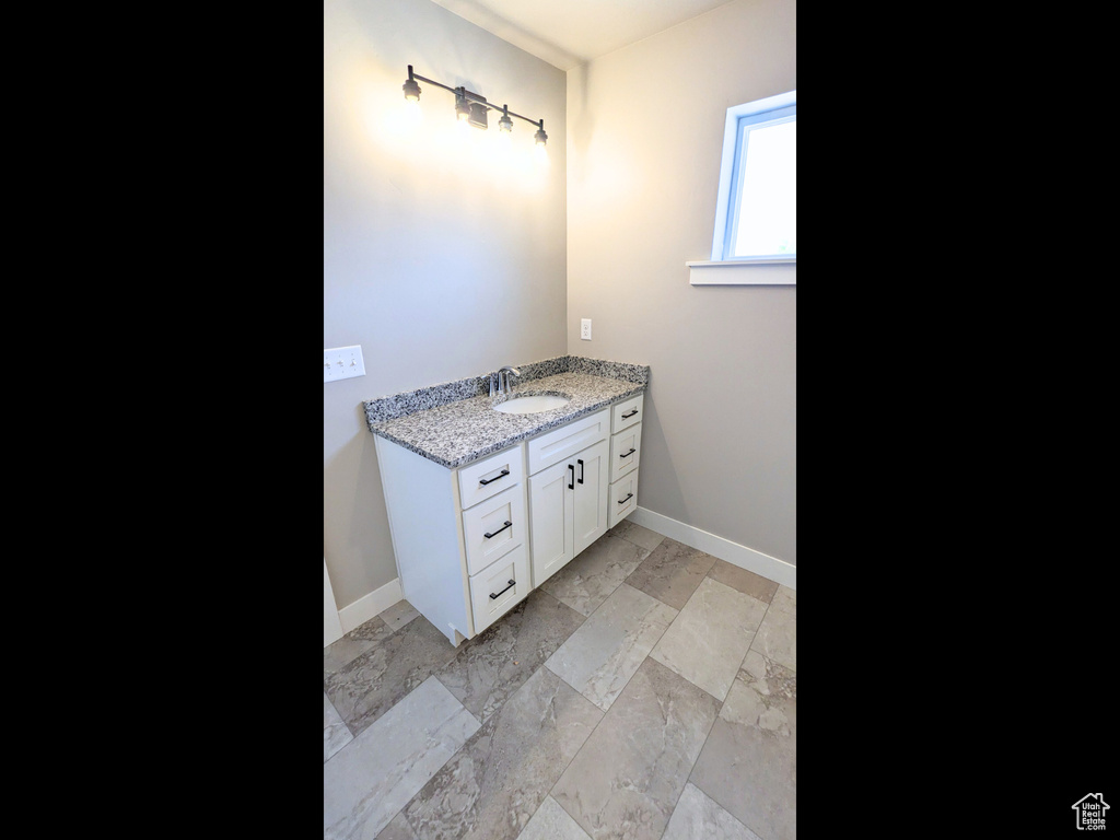 Bathroom featuring vanity and tile patterned floors