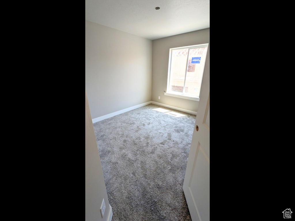 Spare room featuring carpet flooring