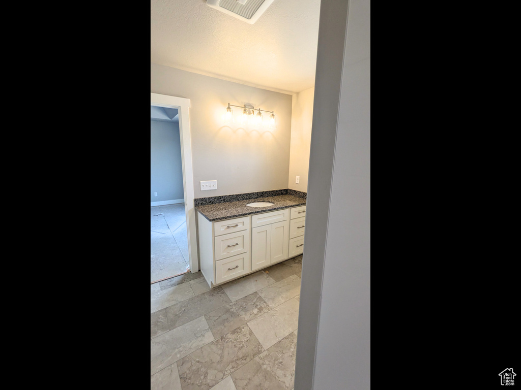 Bathroom with vanity and tile patterned flooring