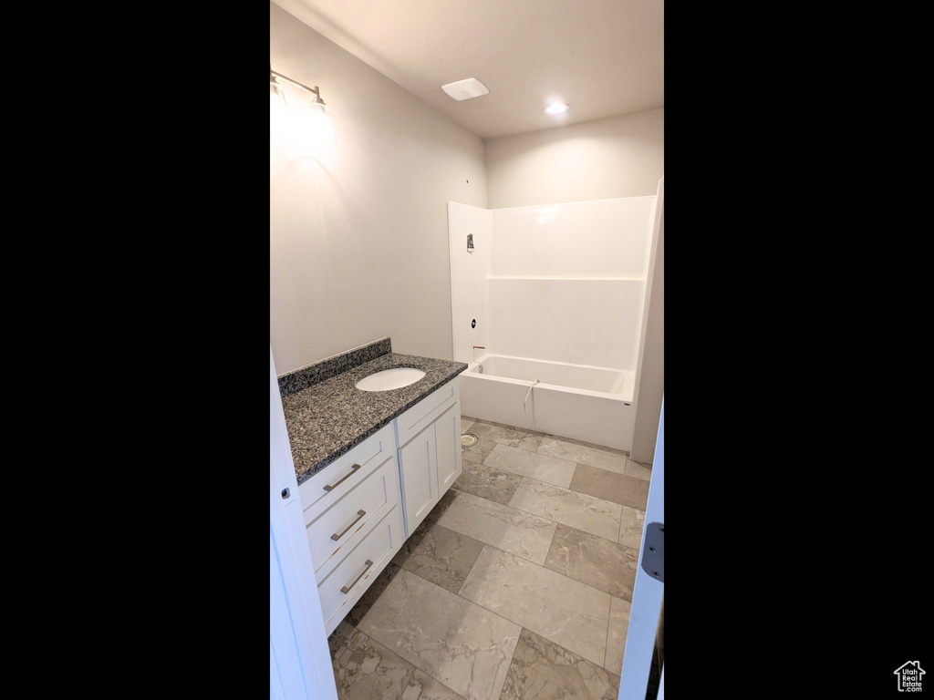 Bathroom with vanity, tile patterned flooring, and  shower combination