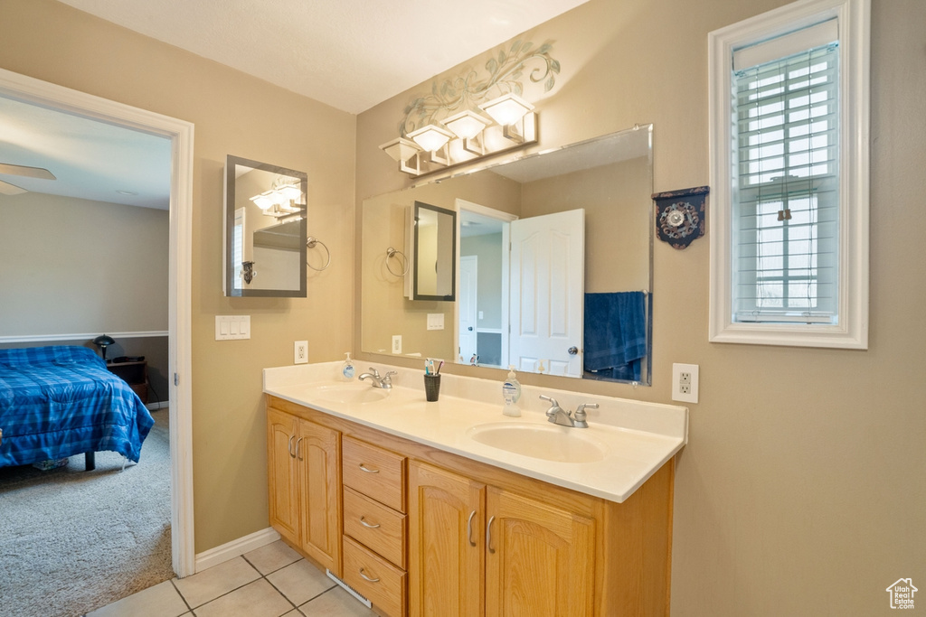 Bathroom with ceiling fan, double vanity, and tile flooring