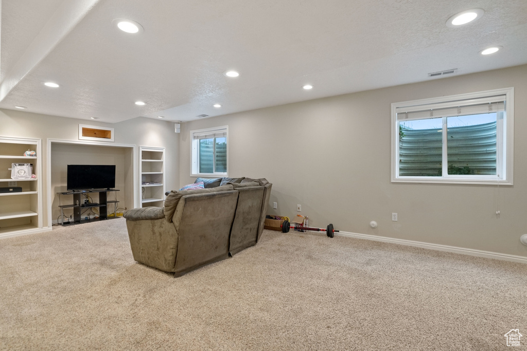 Living room featuring a textured ceiling and carpet floors