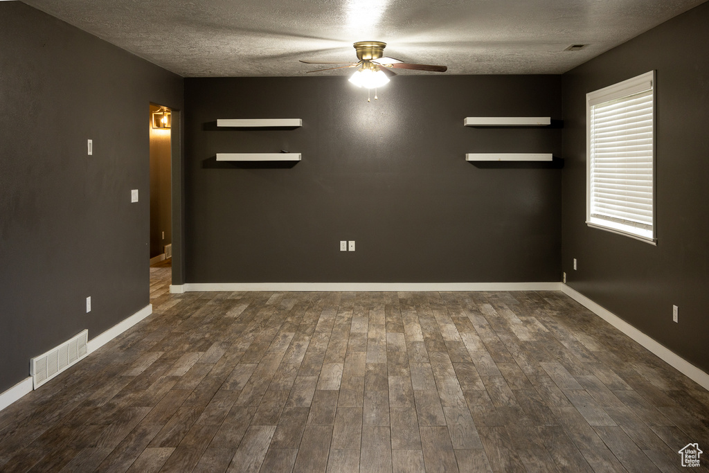 Unfurnished room with a textured ceiling, ceiling fan, and hardwood / wood-style floors