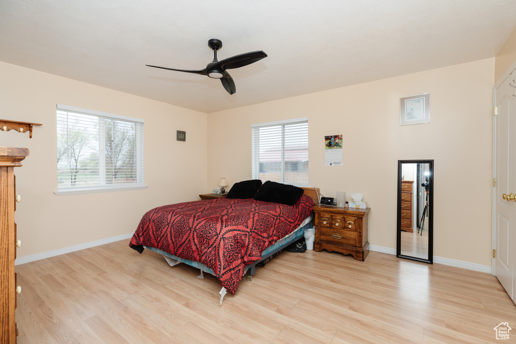 Bedroom featuring ceiling fan and hardwood / wood-style flooring