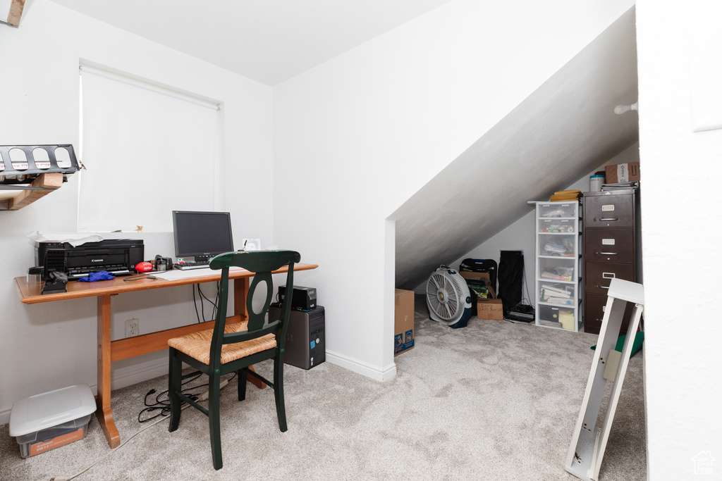 Carpeted office featuring lofted ceiling
