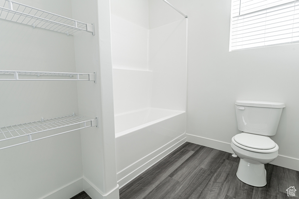Bathroom with toilet and hardwood / wood-style floors