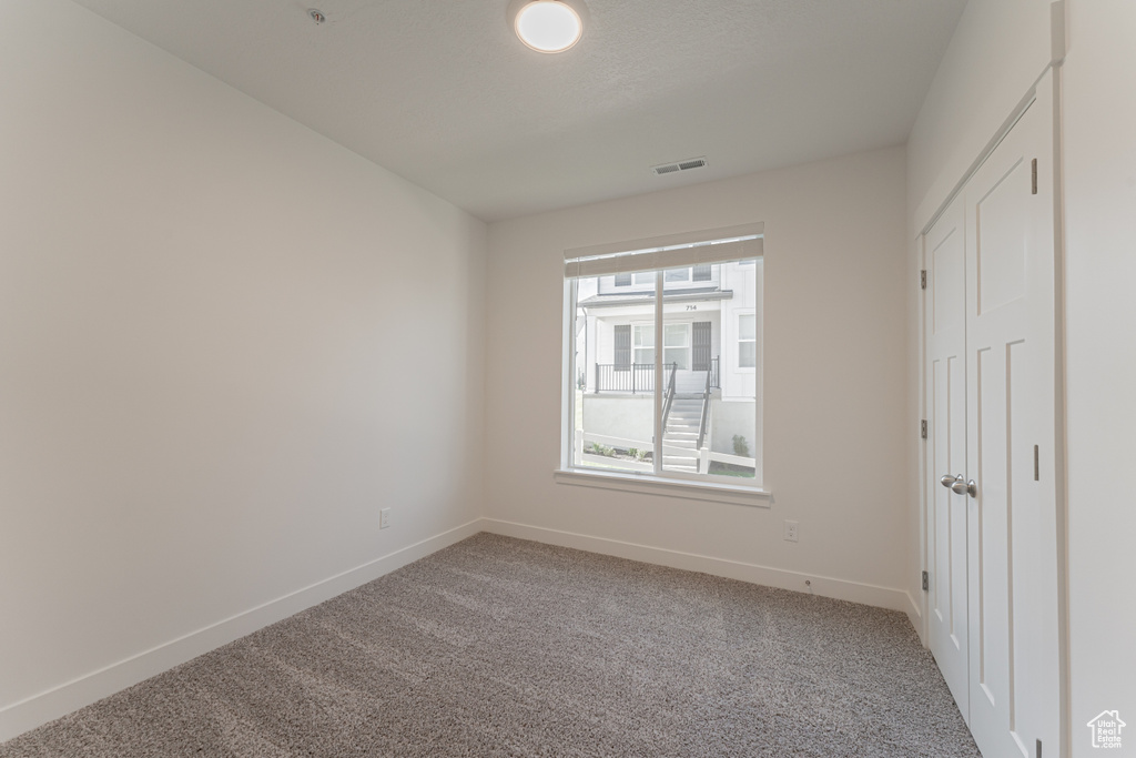 Empty room with carpet floors