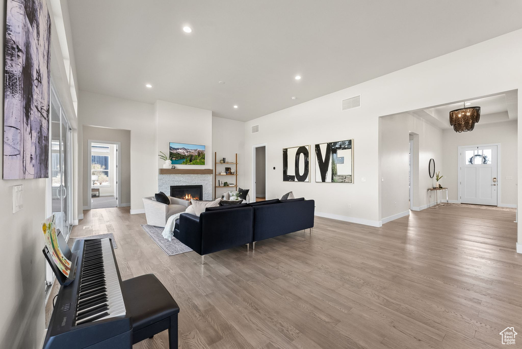 Living room with hardwood / wood-style floors and a stone fireplace