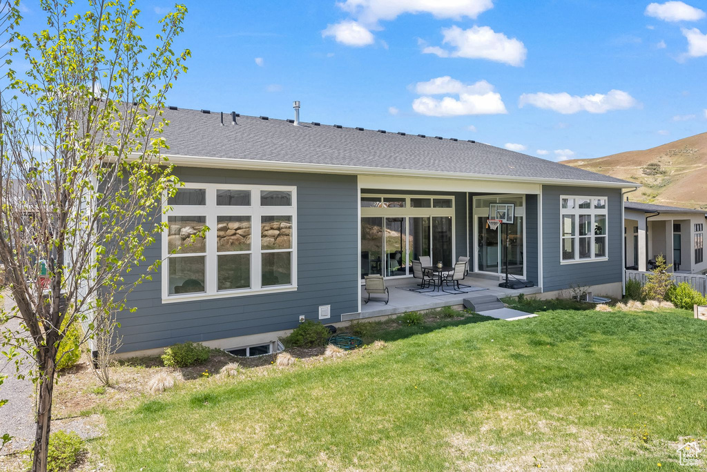 Back of property featuring a patio area and a yard