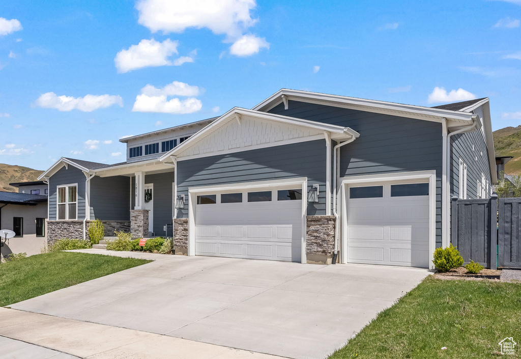 View of front of property with a garage and a porch