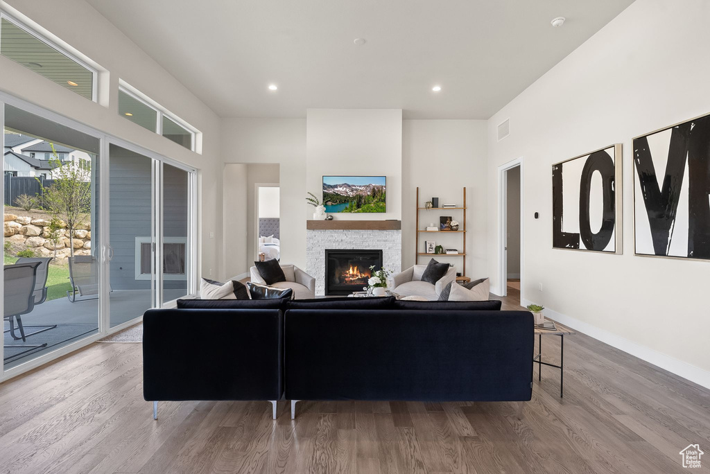 Living room with a fireplace and hardwood / wood-style floors