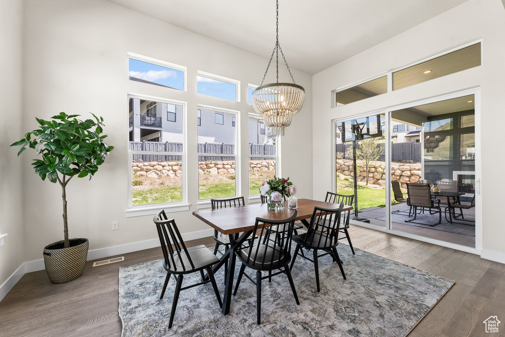 Dining room featuring dark hardwood / wood-style floors and a notable chandelier