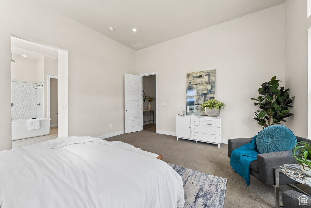 Bedroom featuring ensuite bath and carpet flooring