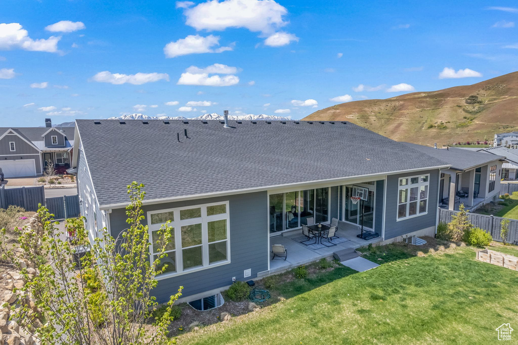 Back of property featuring a patio and a yard