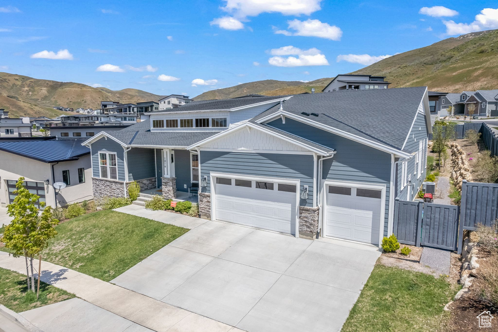 View of front of property with a garage and a mountain view