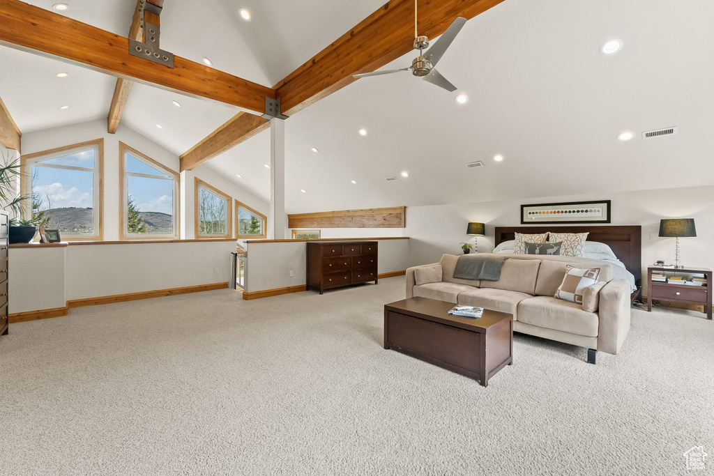 Carpeted living room featuring high vaulted ceiling, beam ceiling, and ceiling fan