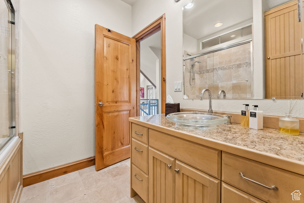 Bathroom featuring backsplash, tile floors, and oversized vanity