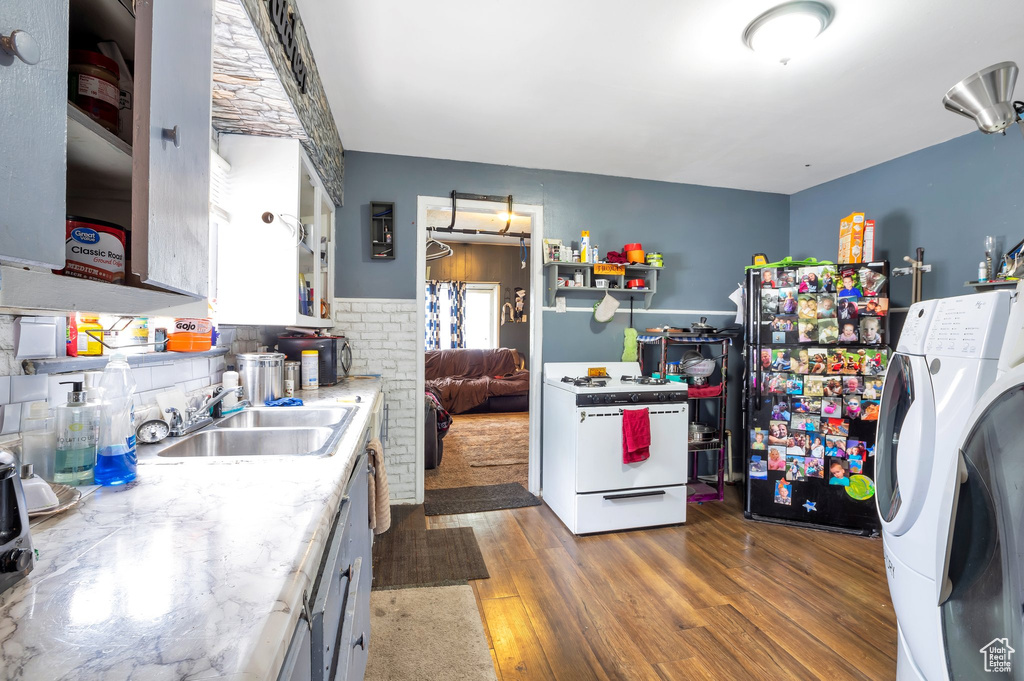 Kitchen featuring sink, dark hardwood / wood-style floors, and white gas range