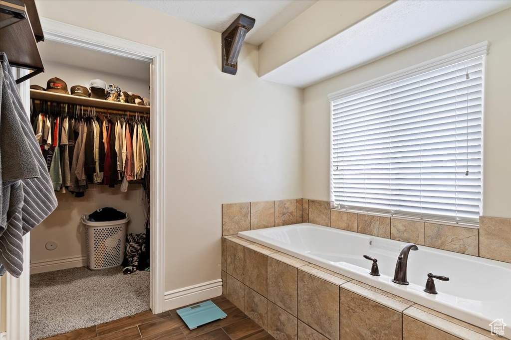 Bathroom featuring a relaxing tiled bath