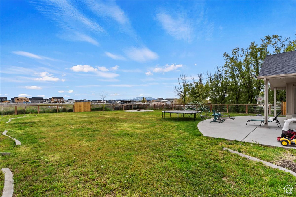 View of yard featuring a patio area and a trampoline