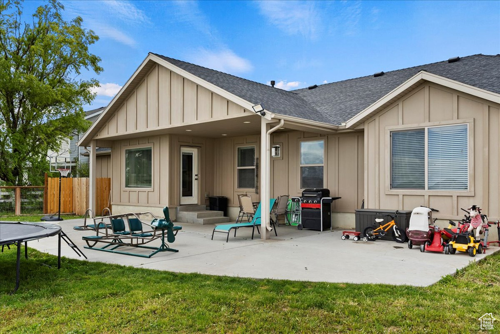 Back of property featuring a patio and a yard