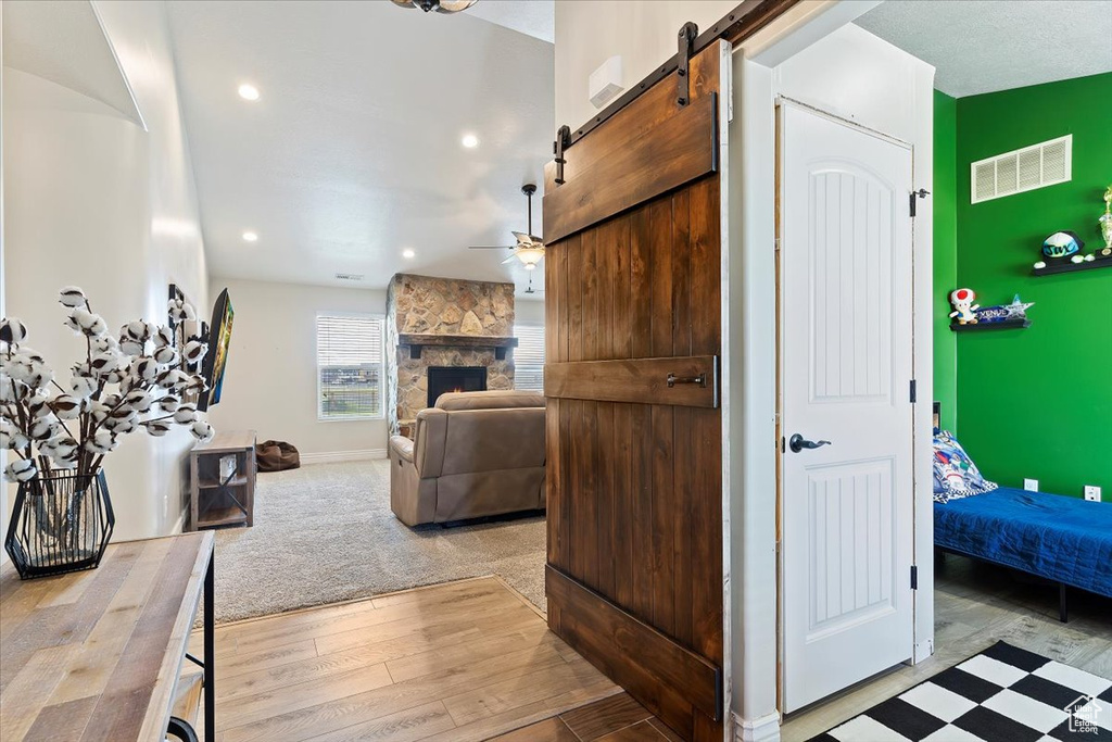 Interior space with a stone fireplace and a barn door