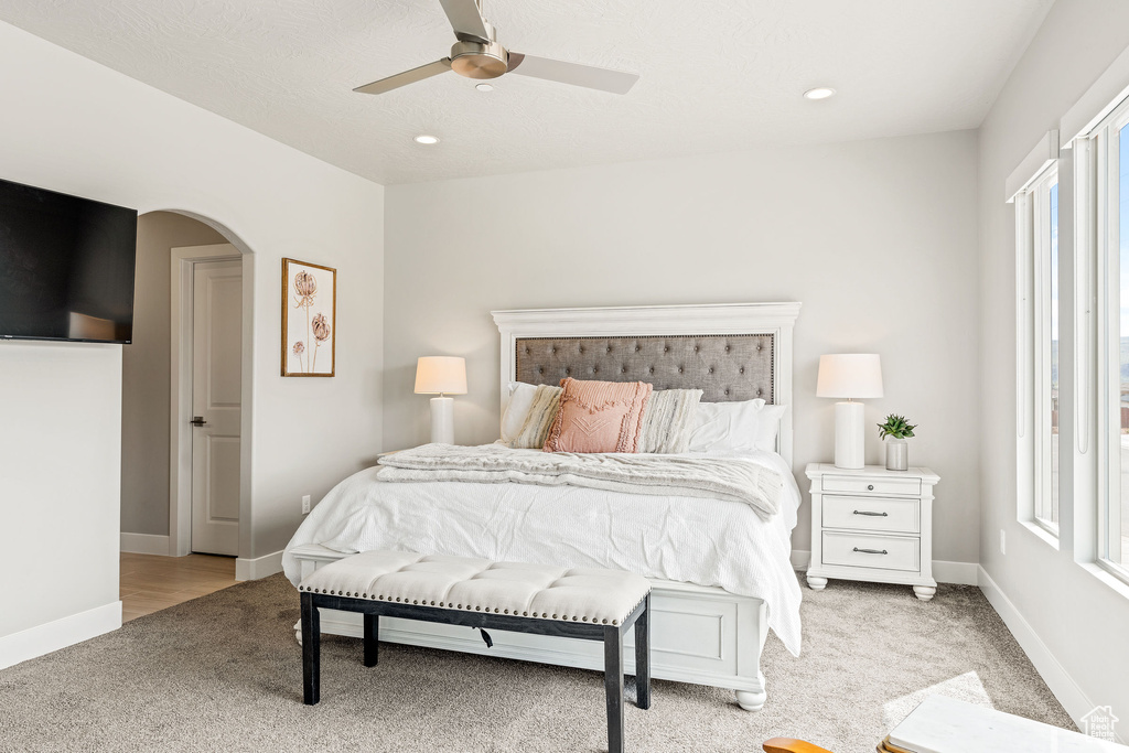 Carpeted bedroom with ceiling fan