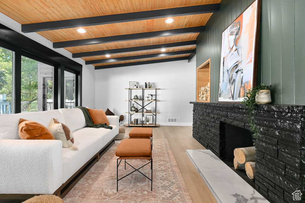 Living room featuring wood ceiling, wood-type flooring, and lofted ceiling with beams