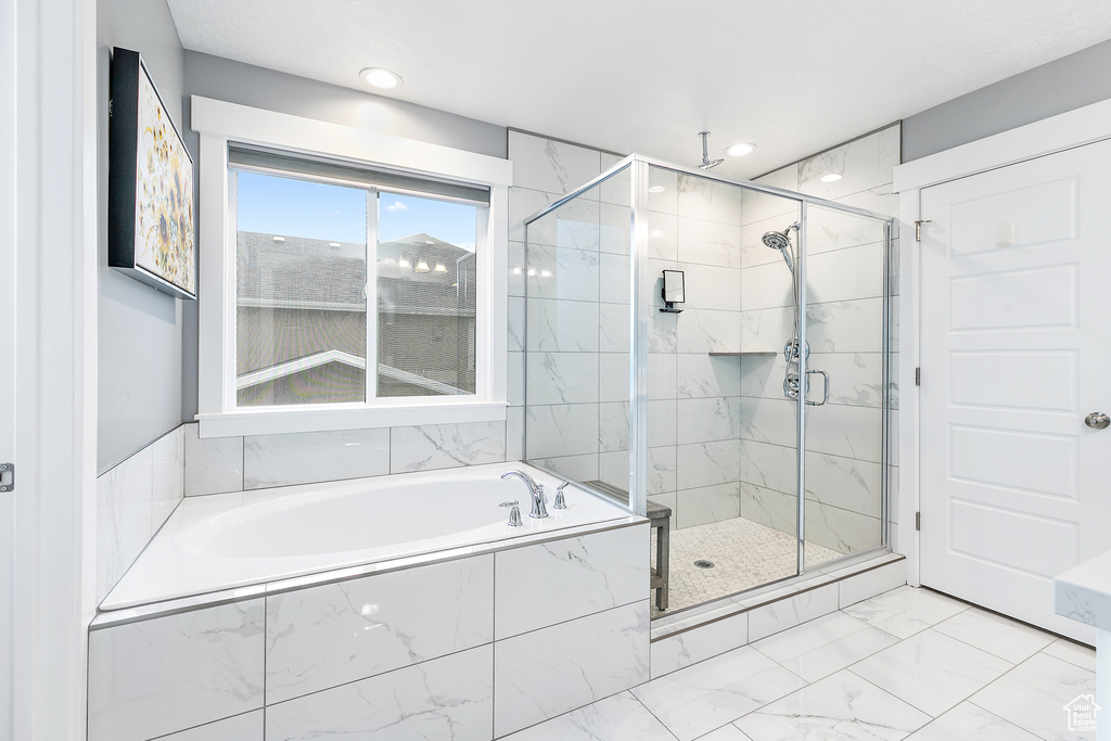 Bathroom with tile floors and separate shower and tub