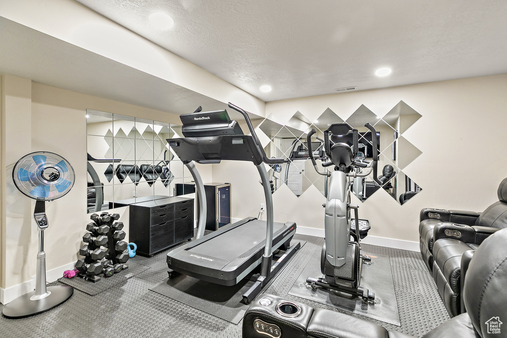 Exercise room with a textured ceiling