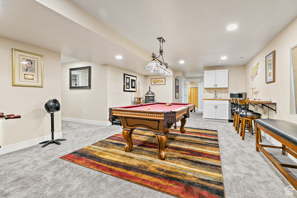 Playroom with light carpet, sink, and pool table