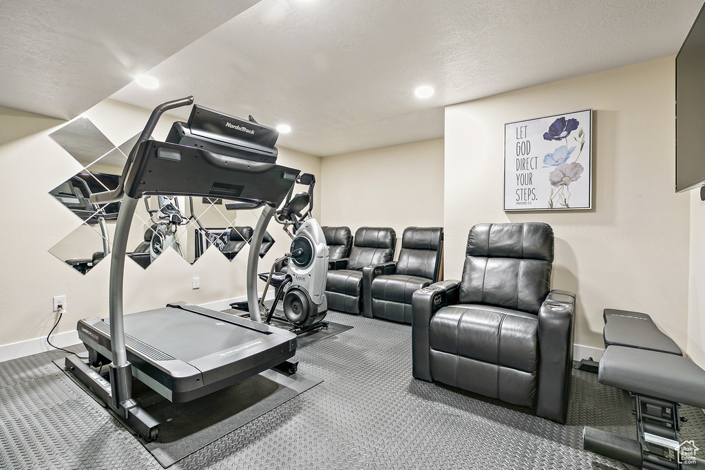 Workout room with carpet floors and a textured ceiling