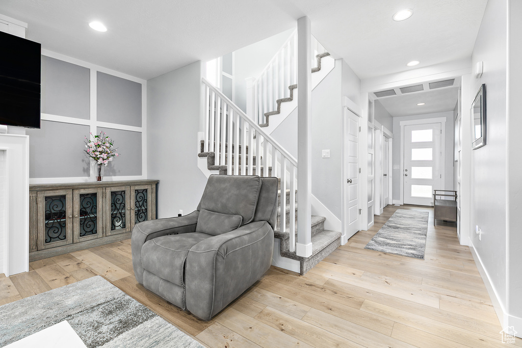 Entrance foyer with light wood-type flooring