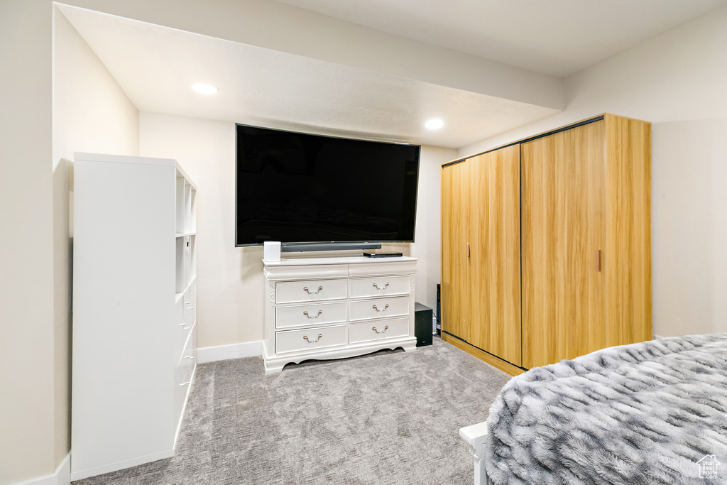 Carpeted bedroom featuring a closet