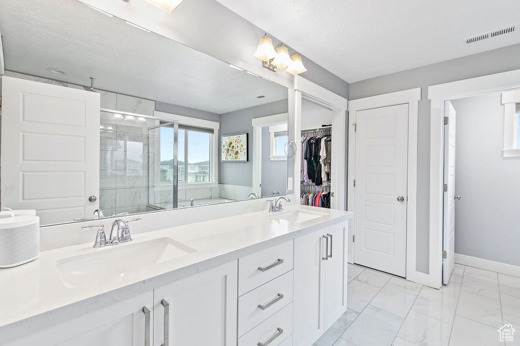 Bathroom featuring double vanity and tile floors