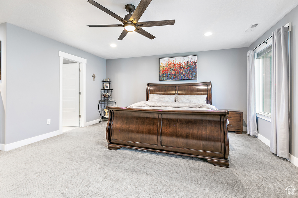 Carpeted bedroom with ceiling fan