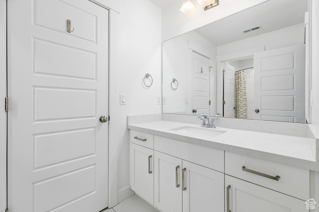 Bathroom with vanity and tile floors