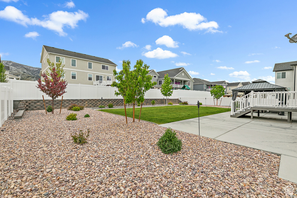 View of yard with a wooden deck