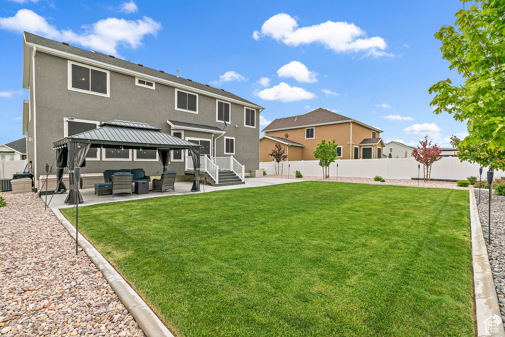 Back of house with a patio, a lawn, a gazebo, and outdoor lounge area