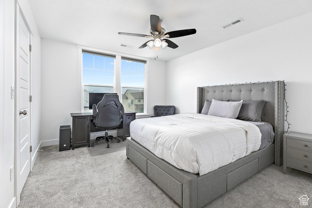 Carpeted bedroom with ceiling fan