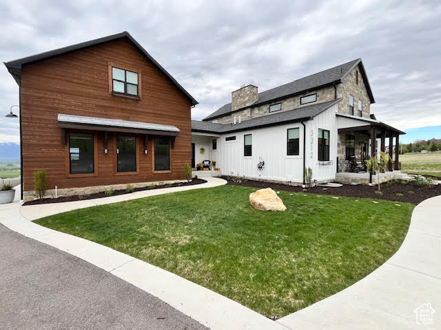 Back of house with a lawn