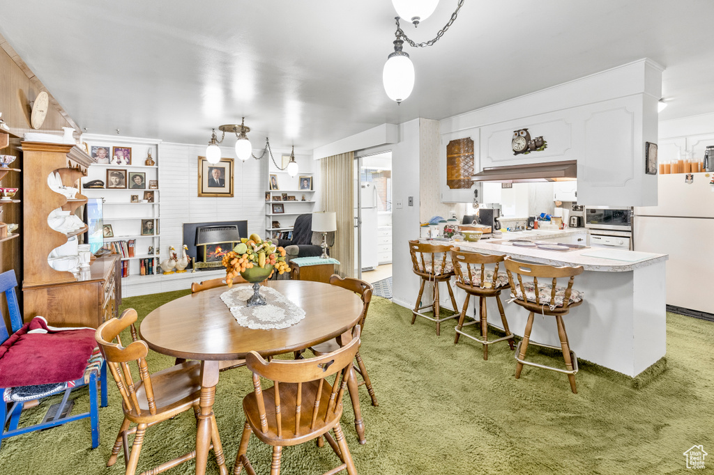 Dining room with carpet and brick wall